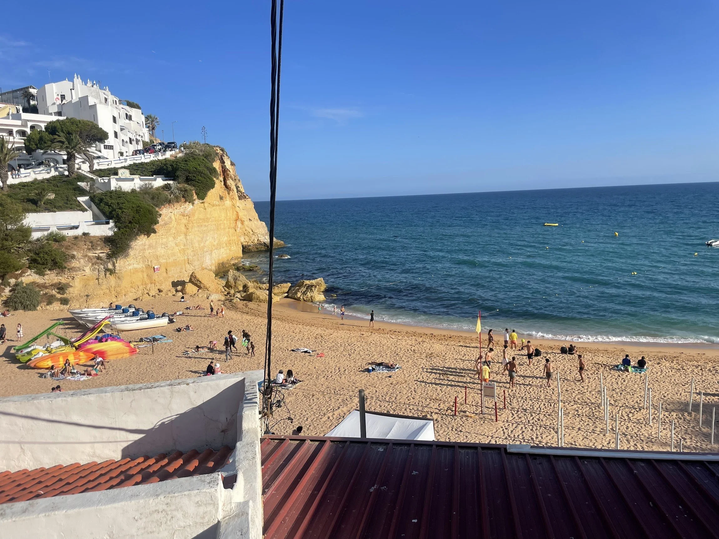 A golden beach with sun loungers beneath the Algarve cliffs