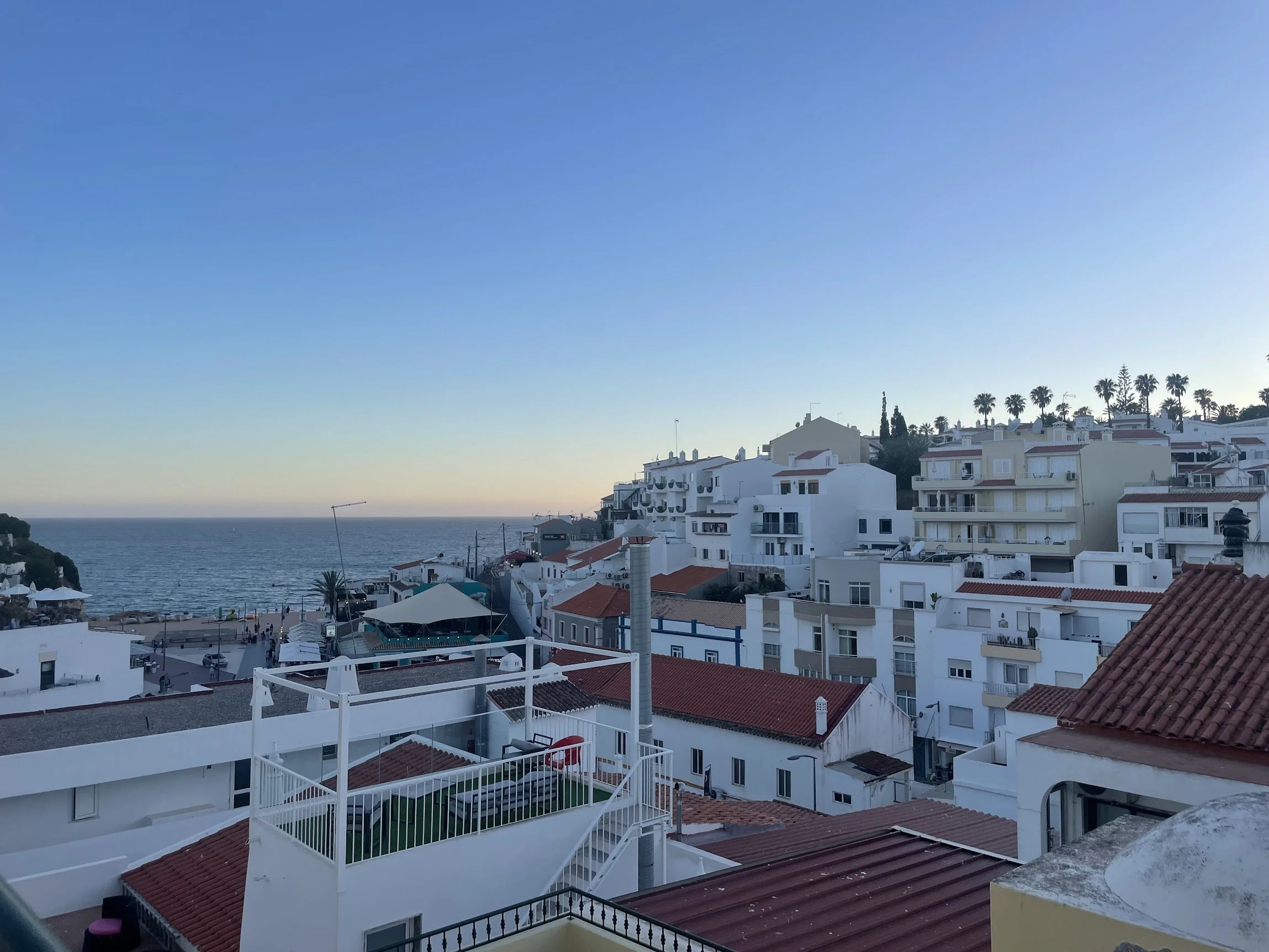 A whitewashed clifftop town glowing at golden hour