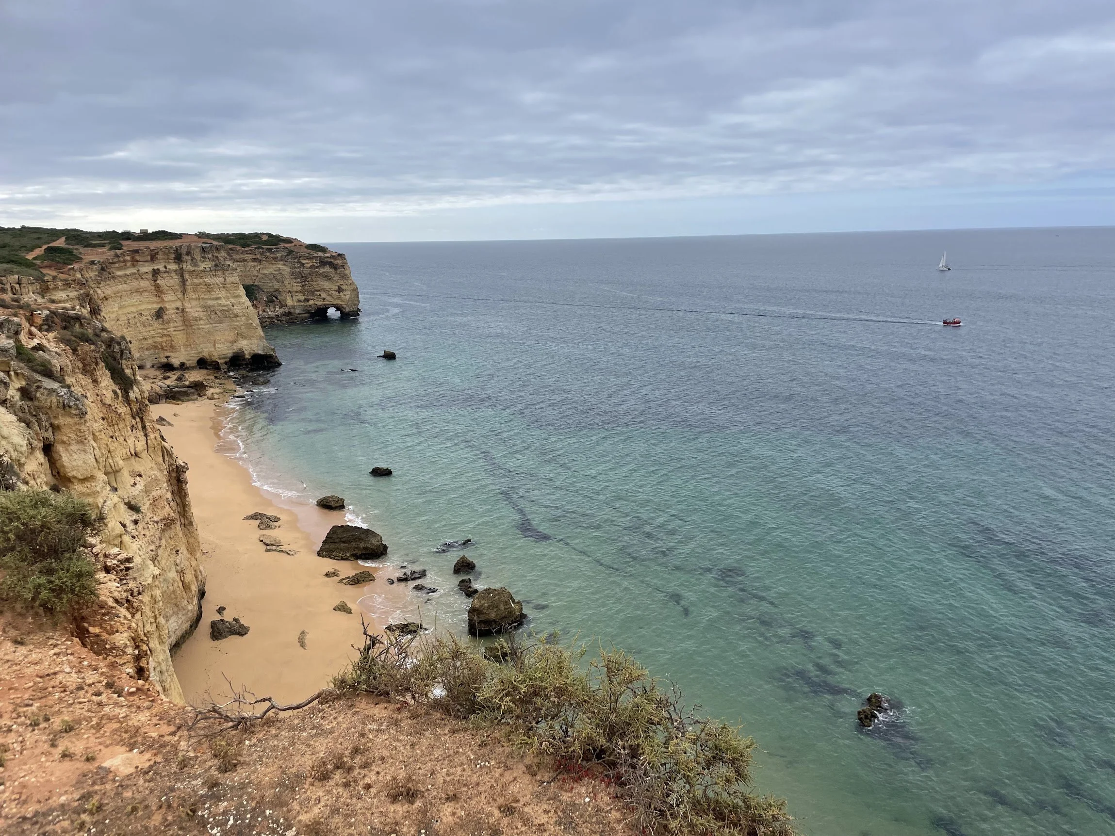 Turquoise water in a cliff-ringed cove on the Algarve coast