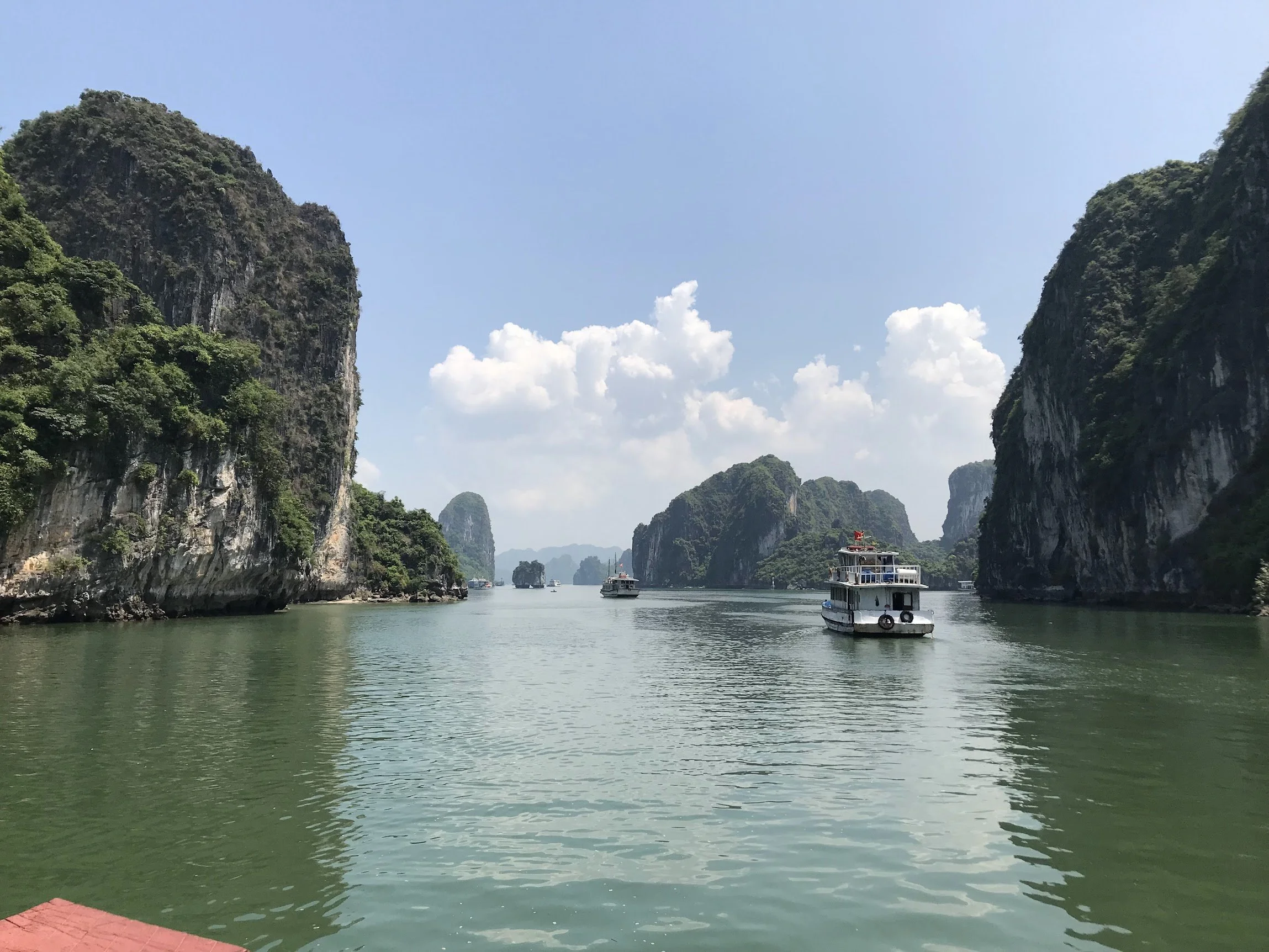 Cruise boats drifting between the karsts of Halong Bay