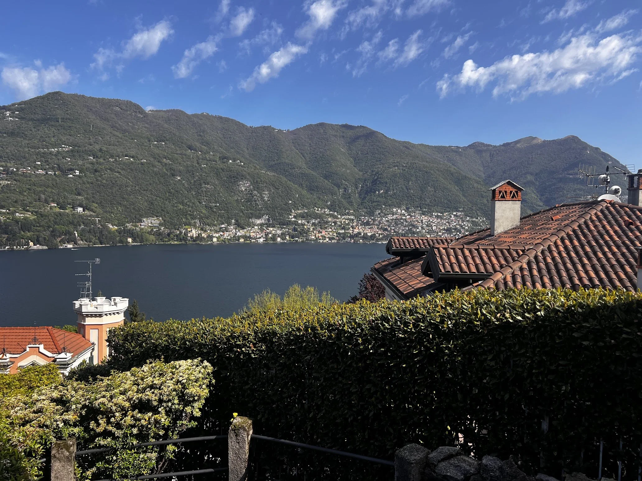 Rooftops above the lake with mountains beyond