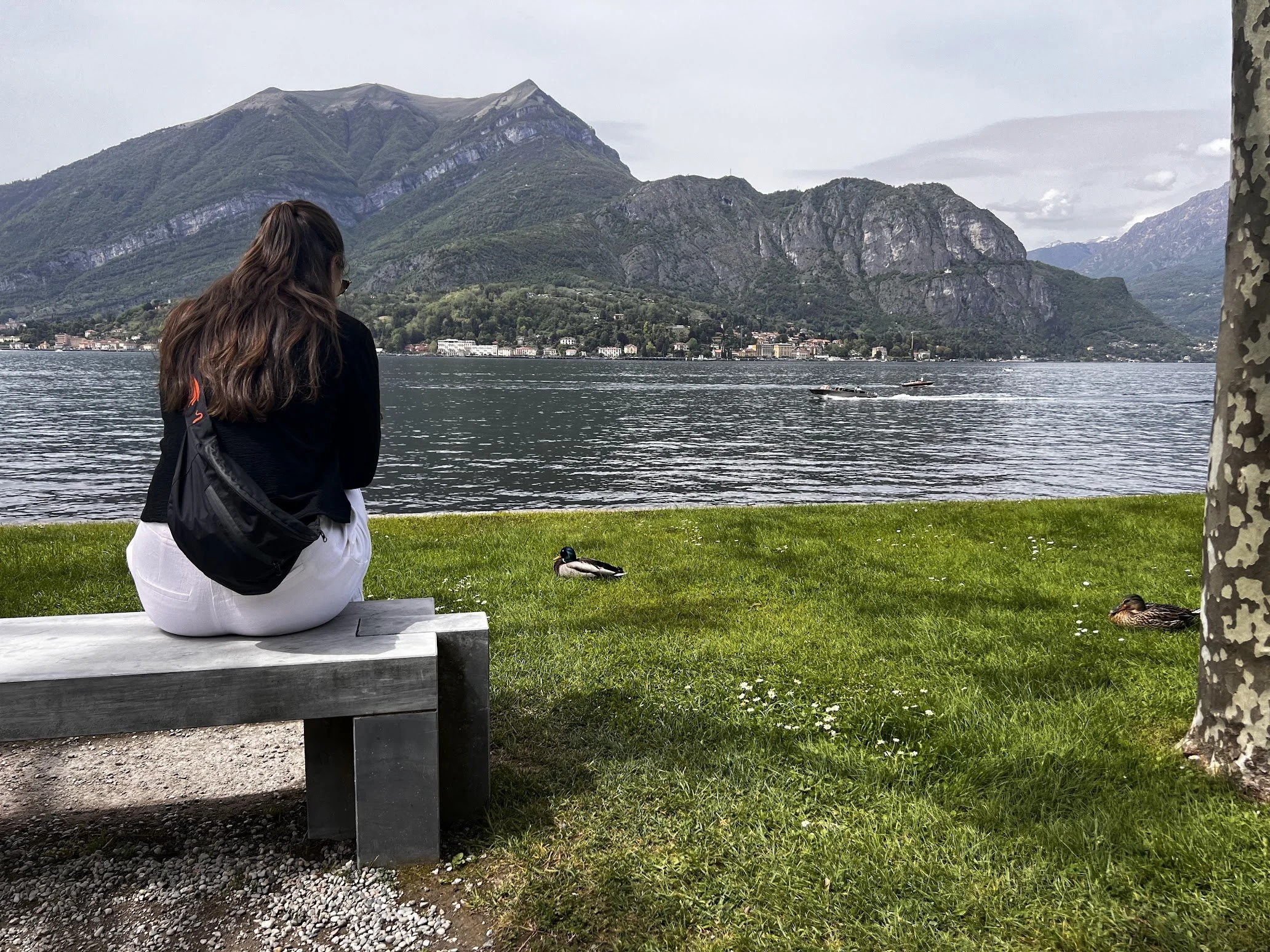 A couple resting on a bench above Lake Como