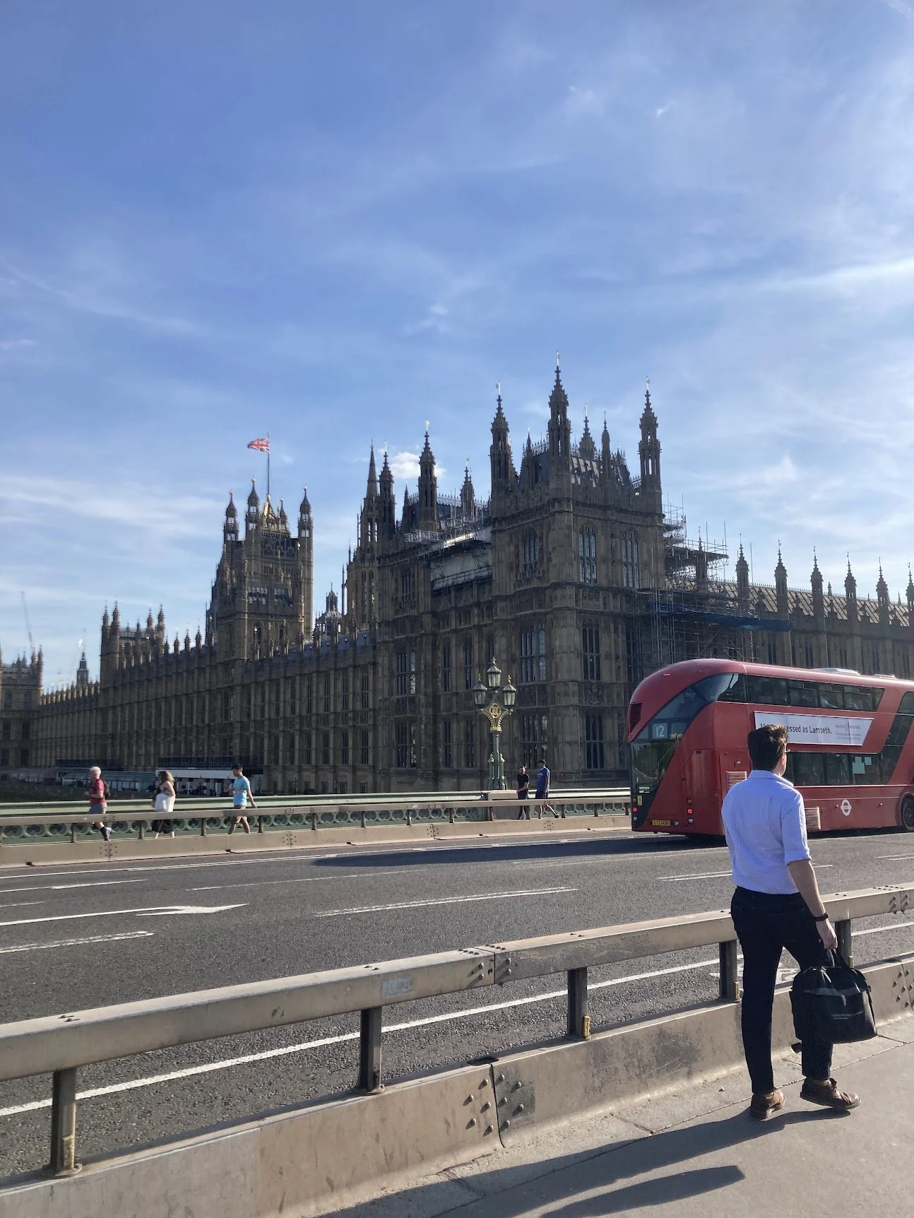 Westminster Abbey with a red double-decker bus passing by