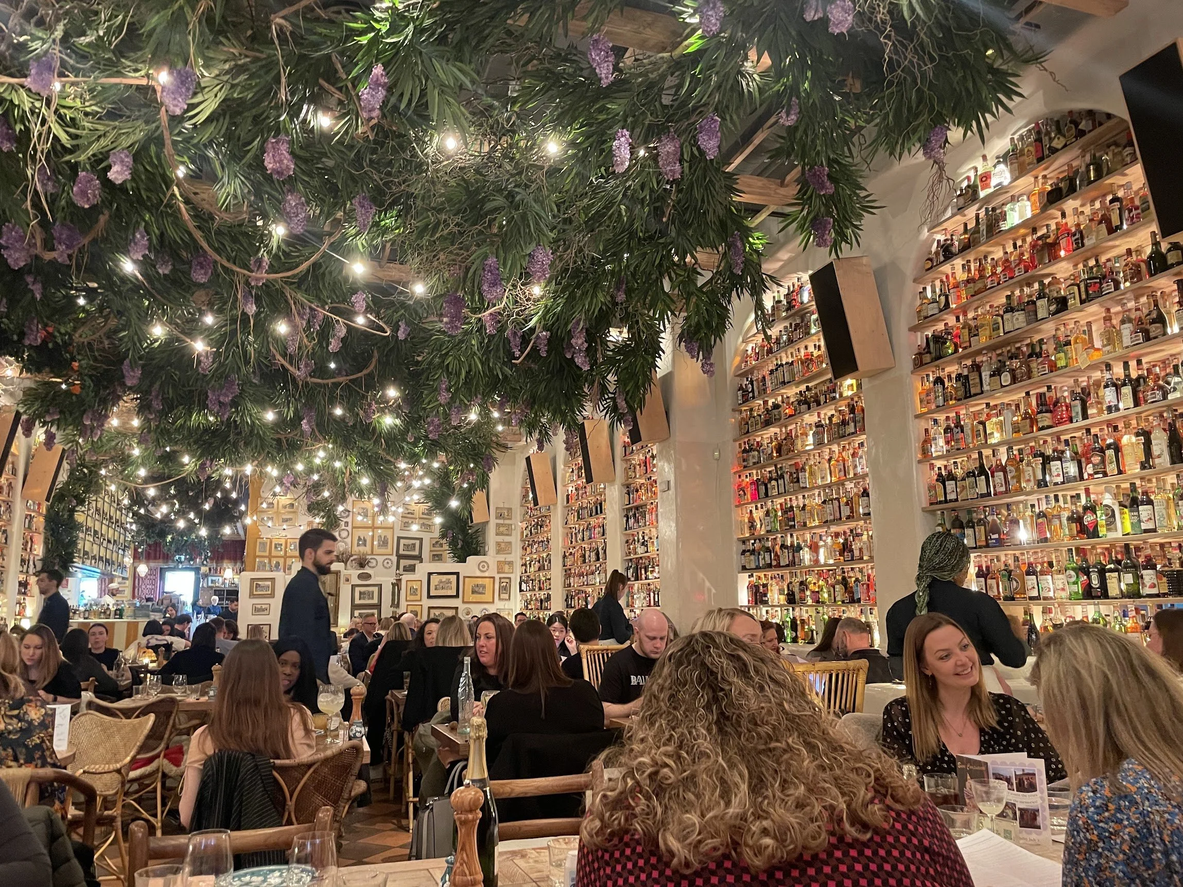 A cosy London pub interior strung with warm lights
