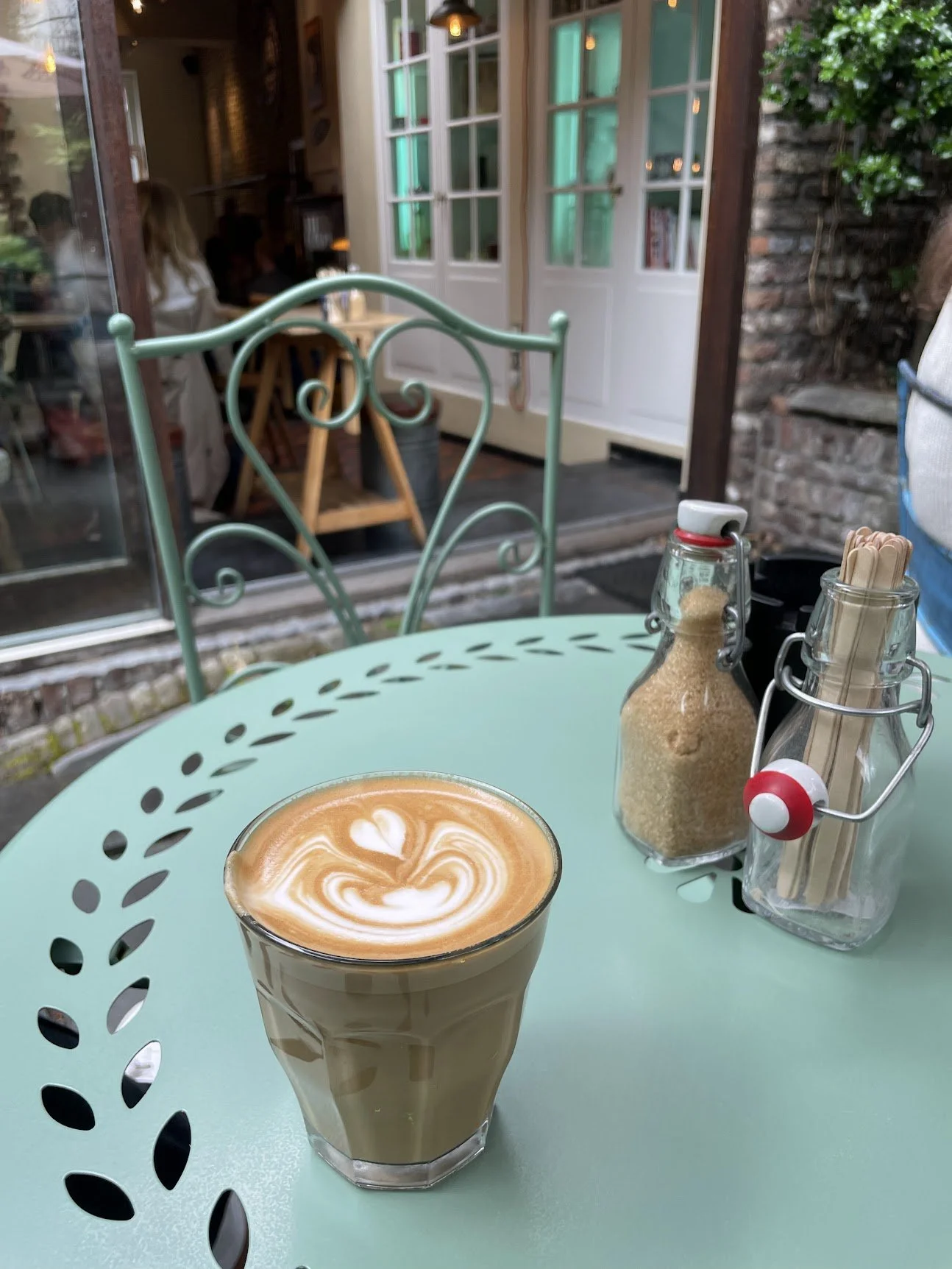 An iced coffee on a colourful café table