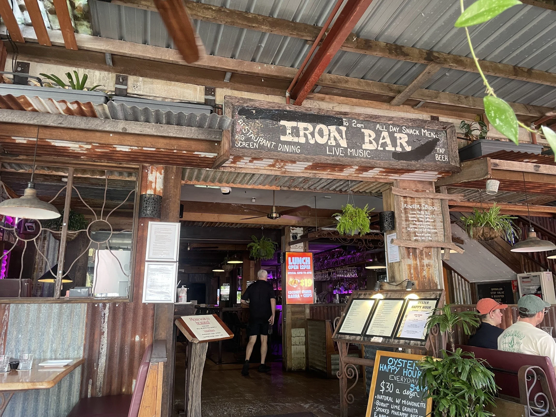 Open-air beachside bar with timber decking in Port Douglas