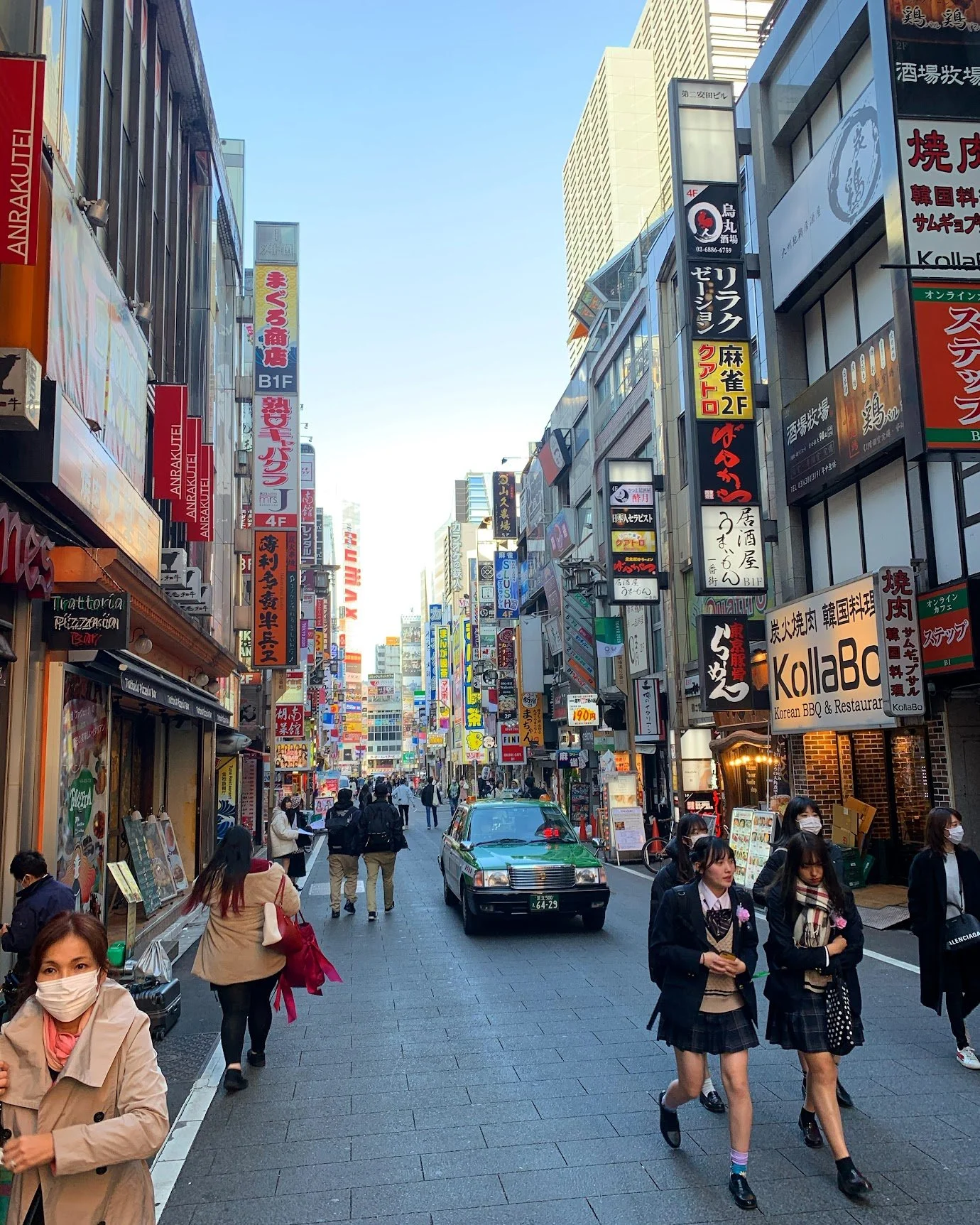 A busy Tokyo shopping street crowded with people