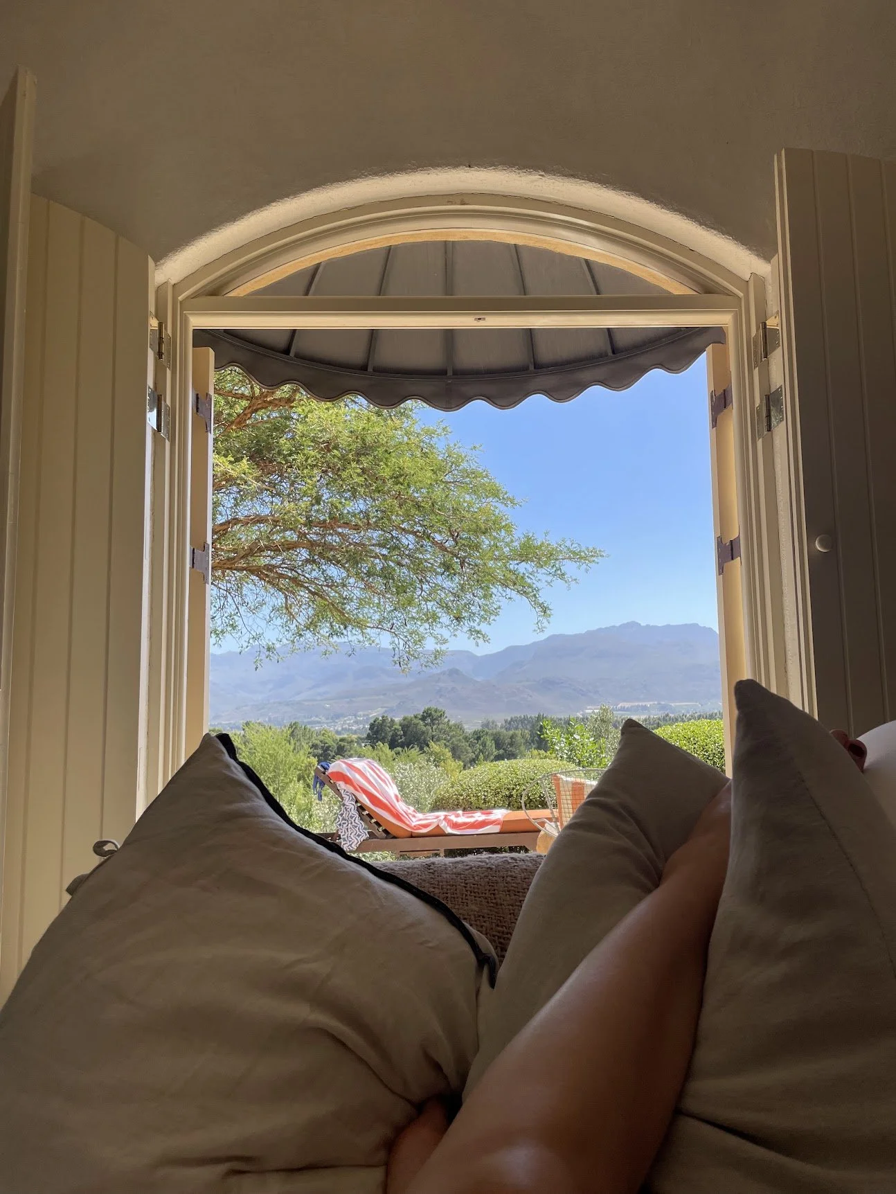 A hammock framing a sea view through an archway